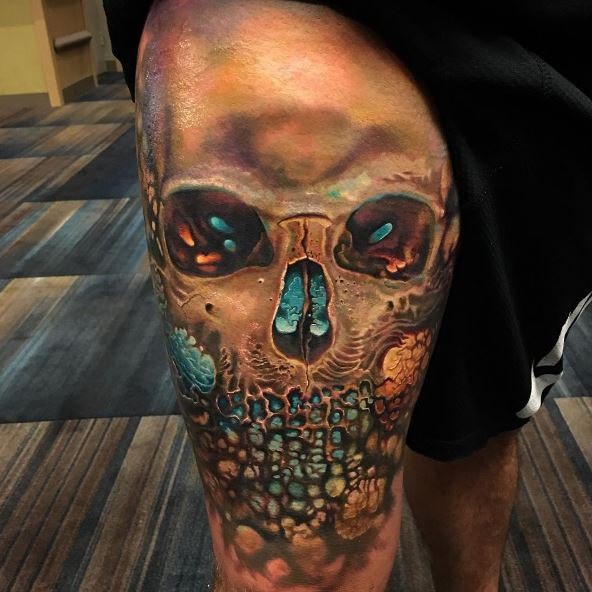 Modern style colored thigh tattoo of mysterious skull