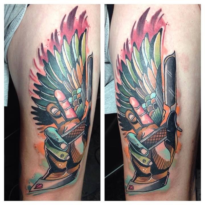 Modern style colored thigh tattoo of human hand with razor blade and wing