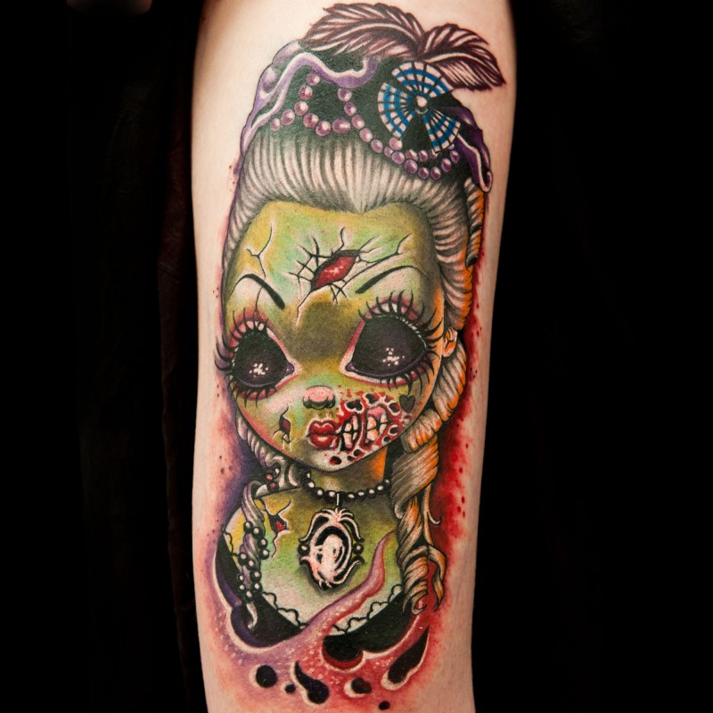 Modern style forearm tattoo of zombie doll