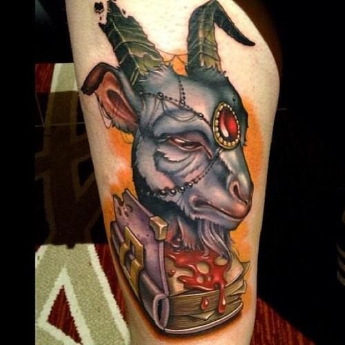 Modern style multicolored bloody fantasy goat head tattoo on thigh with spell book