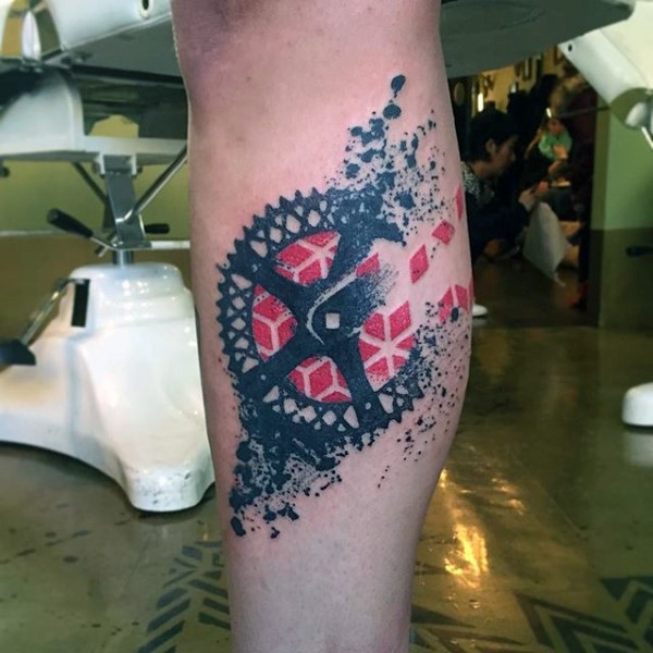 Modern style painted colored bicycle part tattoo on leg
