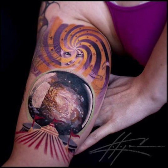 Modern traditional colored biceps tattoo of magical orb with galaxy