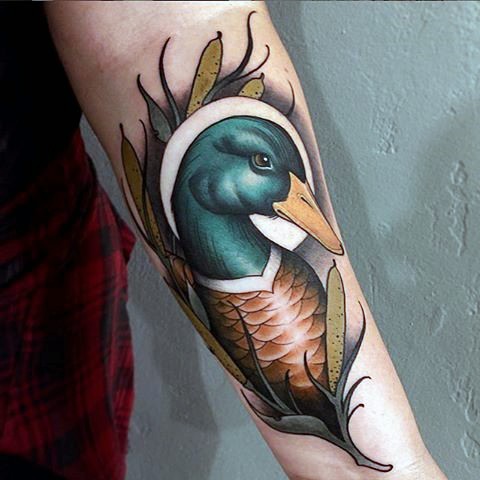 Modern traditional colored forearm tattoo of duck
