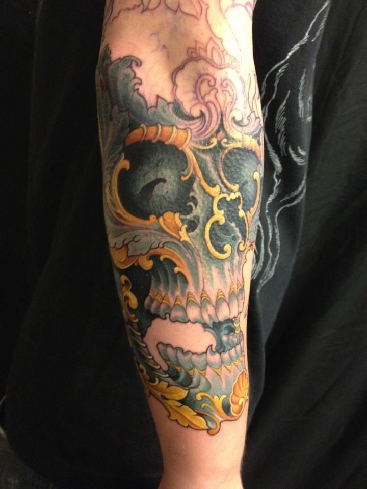 Modern traditional style colored arm tattoo of human skull
