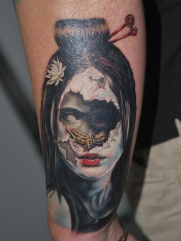 Modern traditional style colored forearm tattoo of creepy woman with butterfly