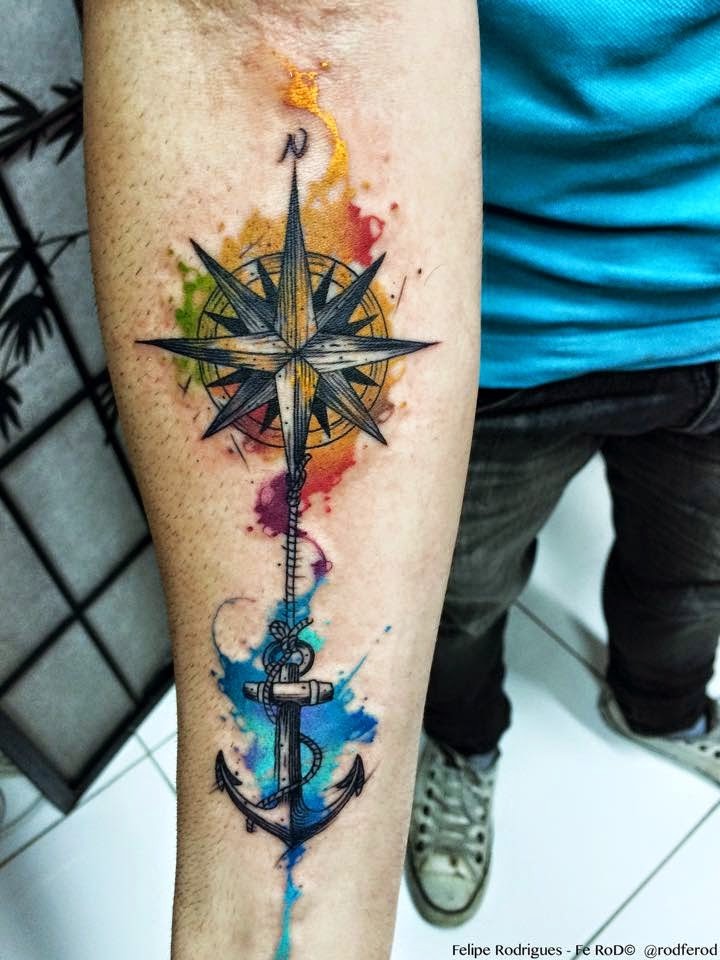 Modern traditional style colored forearm tattoo of compass and roped anchor