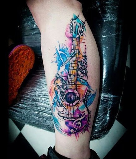 Modern traditional style colored leg tattoo of cool guitar with lettering