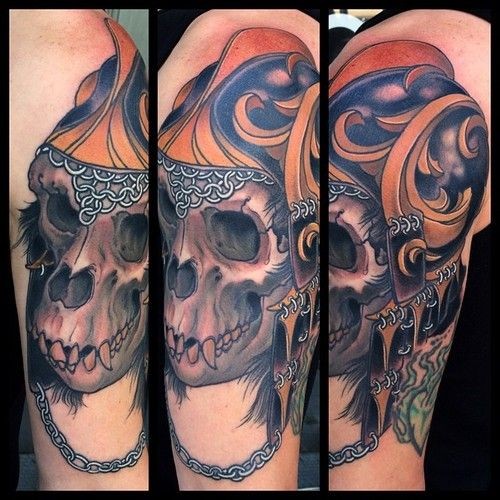 Modern traditional style colored shoulder tattoo of monkey skull with helmet