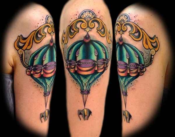 Modern traditional style colored shoulder tattoo of balloon with elephant