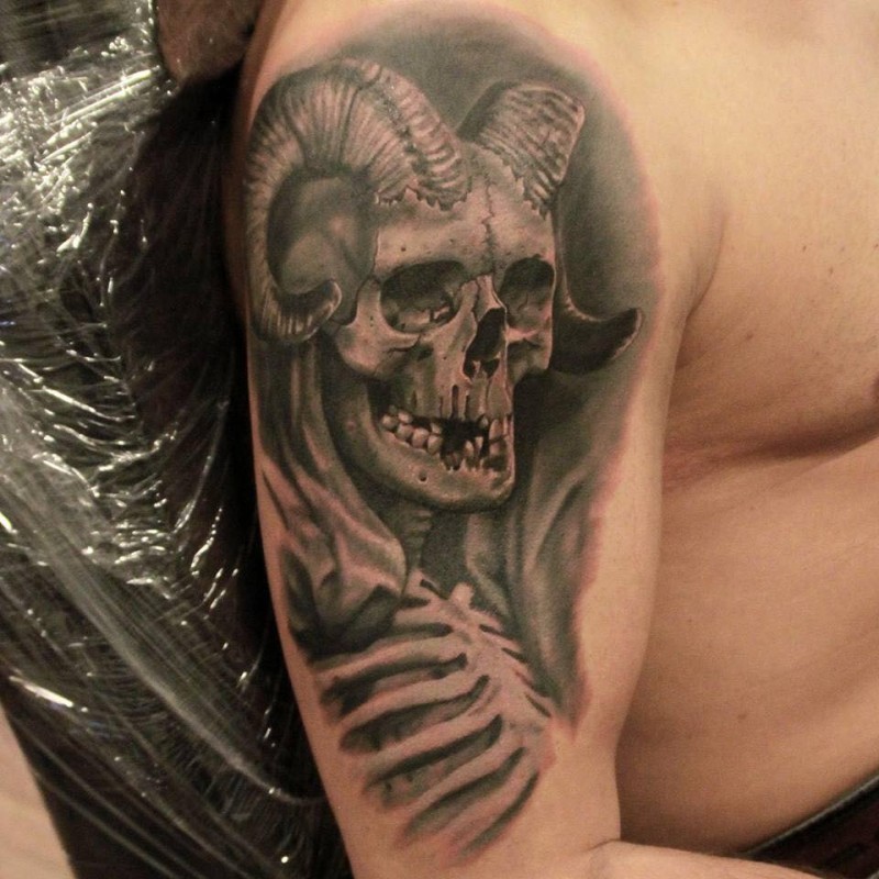 Modern traditional style shoulder tattoo of demonic skull