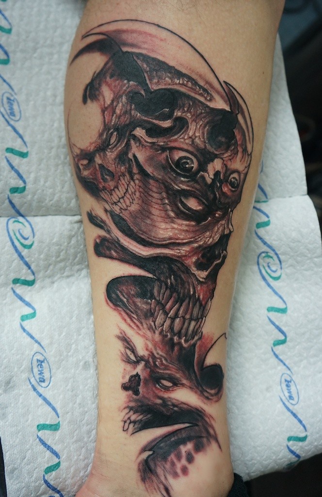 Tatuaggio pauroso sul braccio il mostro con gli occhi