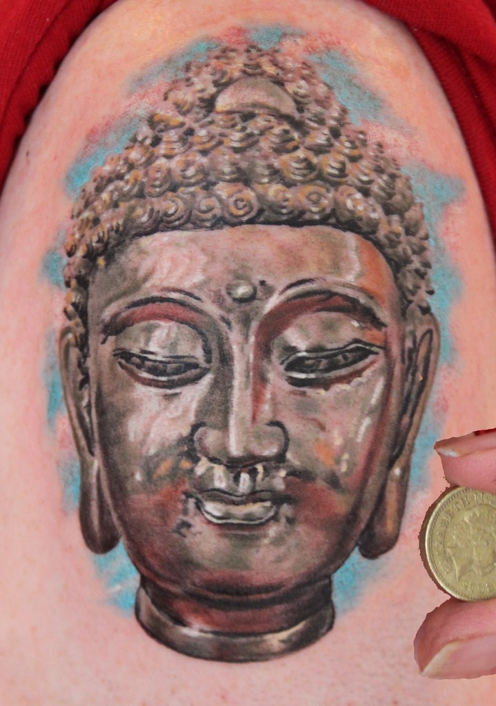 Monumental Buddha's portrait colored detailed shoulder Buddhist tattoo