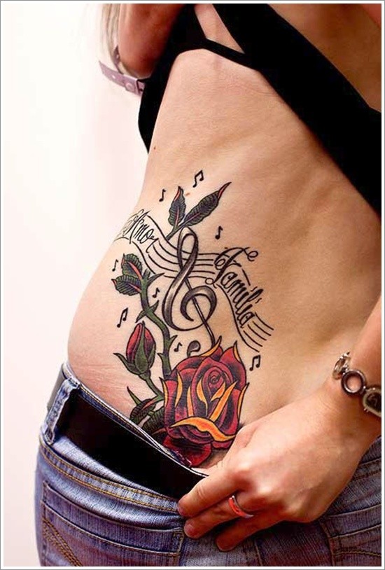 Music themed little notes with lettering and rose tattoo on hip