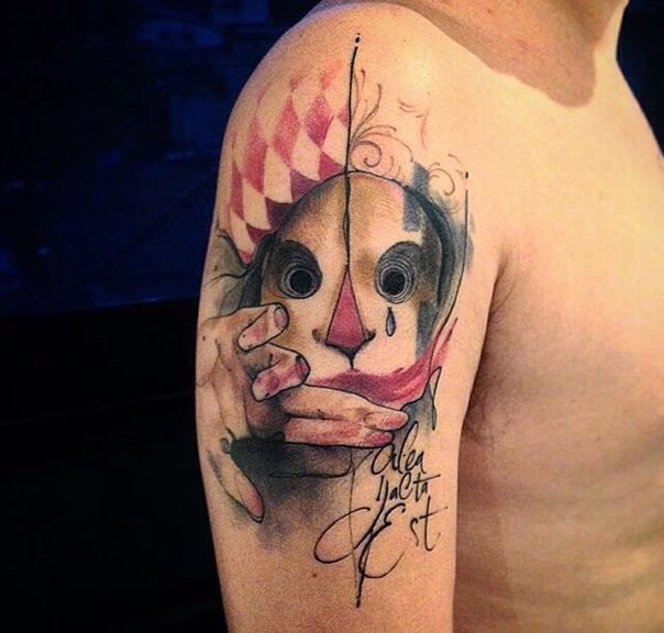 Mysterious colored shoulder tattoo of creepy mask with lettering