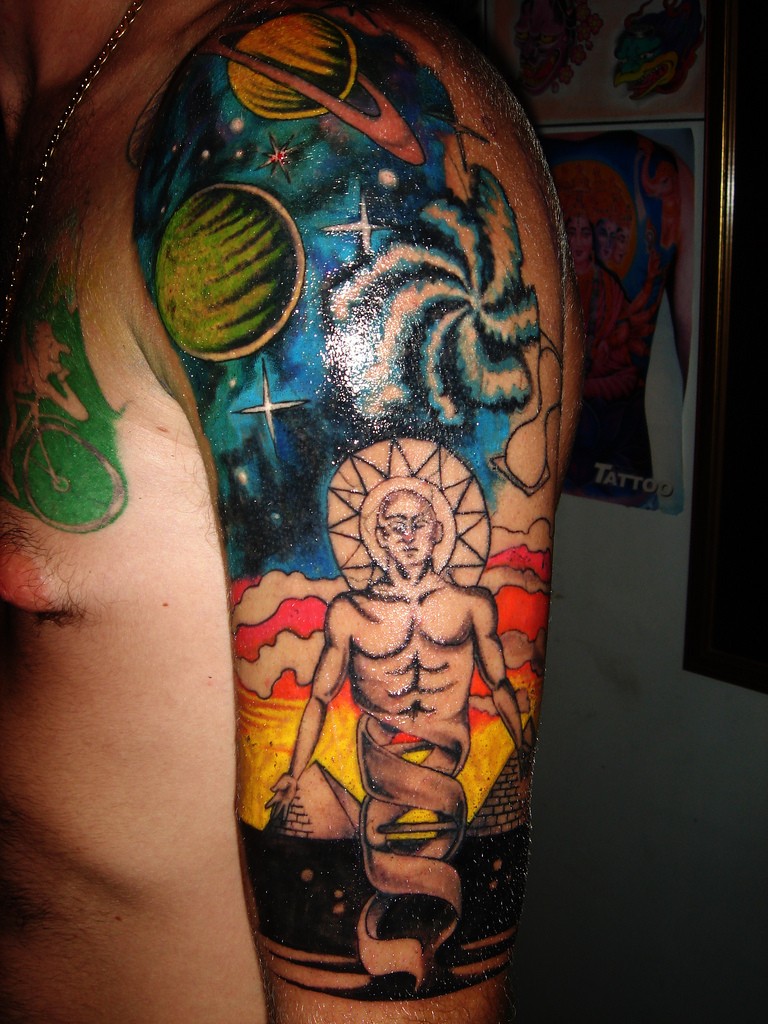 Mysterious illustrative style colored shoulder tattoo of space with interesting human like creature