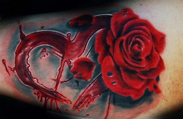 Mystical big bloody red heart with rose tattoo on arm