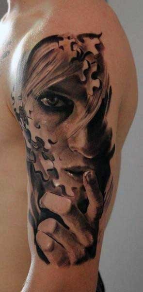 Mystical black and gray style shoulder tattoo of woman portrait stylized with puzzle pieces