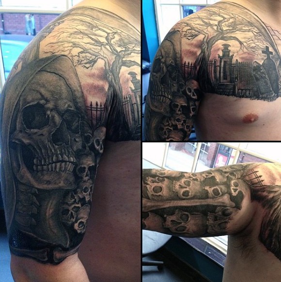 Mystical black and white skulls tattoo on shoulder with cemetery