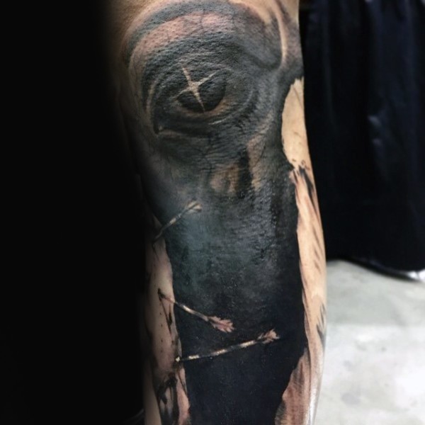 Mystical black ink demonic eye tattoo on arm