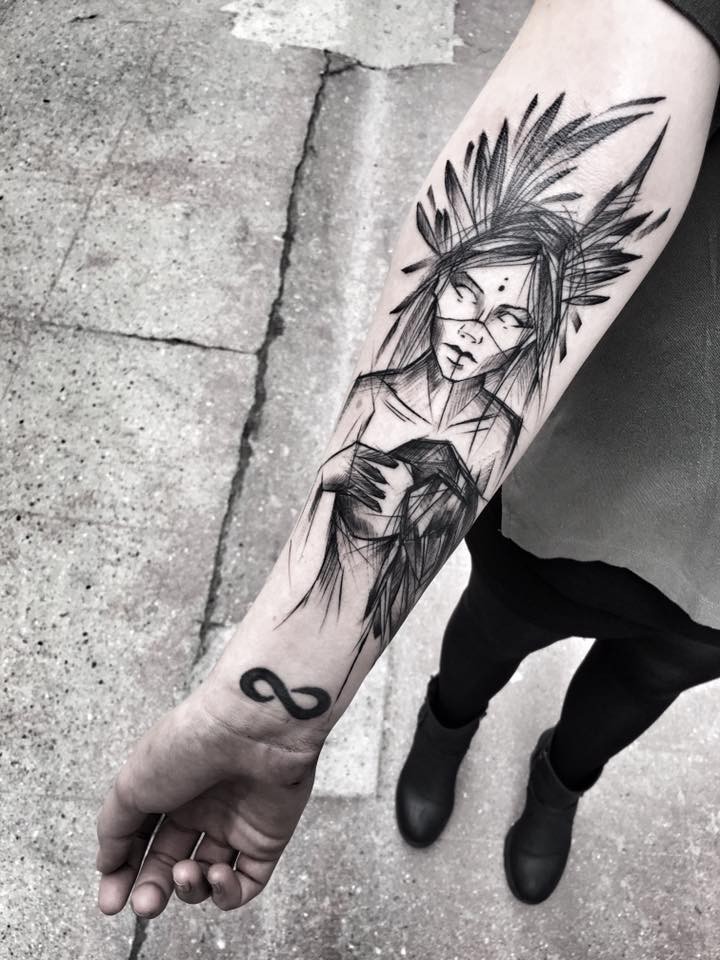 Mystical blackwork style painted by Inez Janiak forearm tattoo of demonic woman with infinity symbol