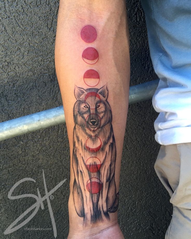 Mystical colored forearm tattoo of wolf with red circles