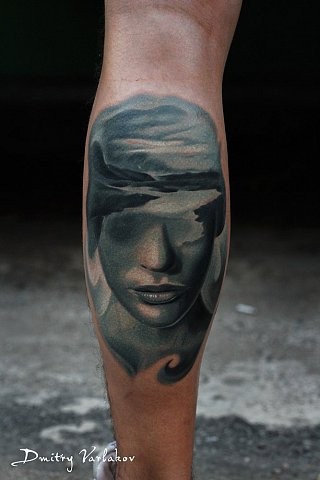 Mystical colored leg tattoo of woman face