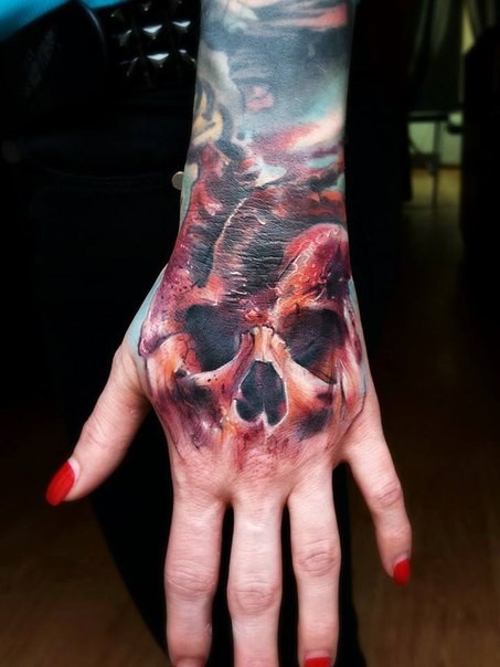 Mystical colored very detailed skull shaped on hand tattoo of heart