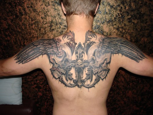 Mystical designed black and white skulls with wings tattoo on upper back