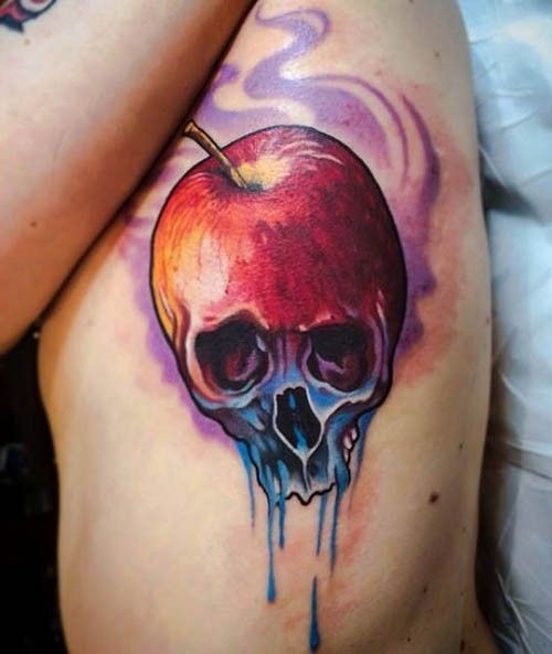 Mystical designed little half apple half skull tattoo on side