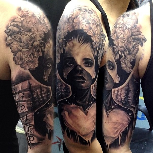 Mystical illustrative style shoulder tattoo of woman face with flowers and lettering