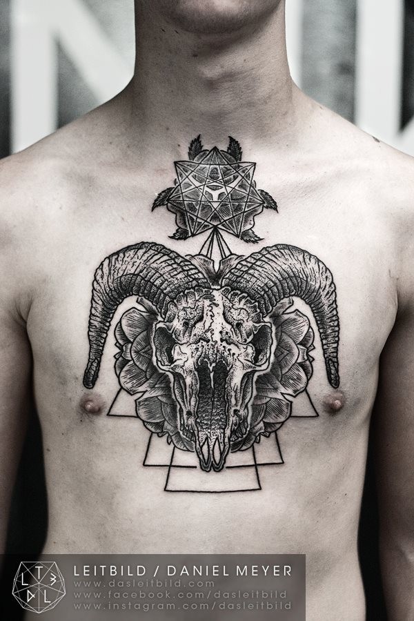 Mystical large chest tattoo of animal skull with various ornaments