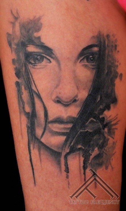 Mystical looking black ink woman face tattoo