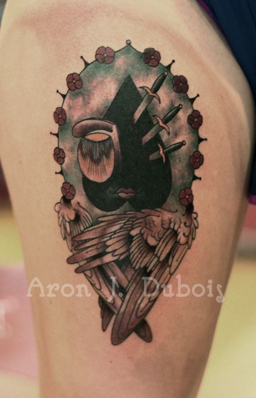 Mystical looking colored thigh tattoo of mystical picture with knifes and wings