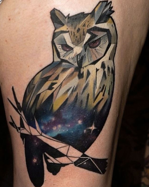 Mystical multicolored thigh tattoo of owl stylized with space