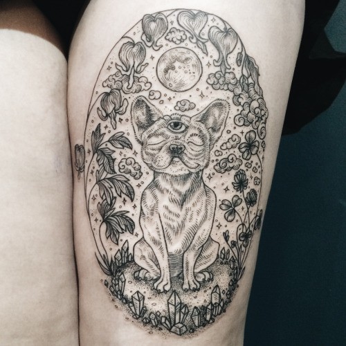 Mystical thigh tattoo of interesting dog with various plants