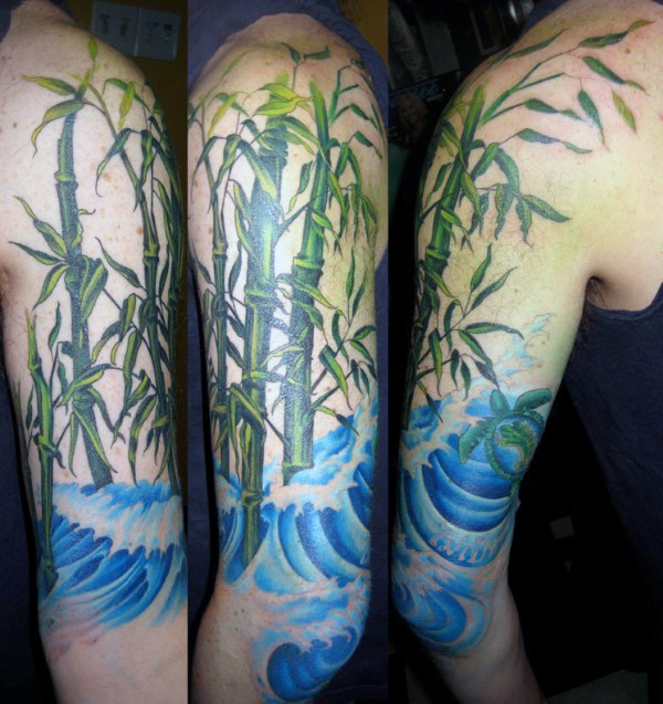 Natural colored large shoulder tattoo of bamboo with waves