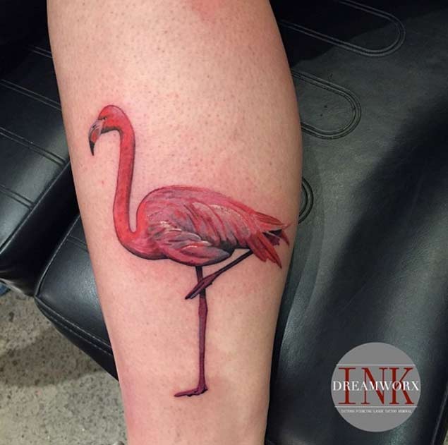 Natural looking beautiful colored leg tattoo of flamingo