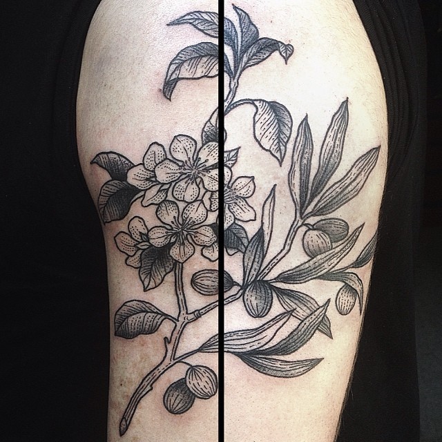 Natural looking black and white shoulder tattoo of flowers