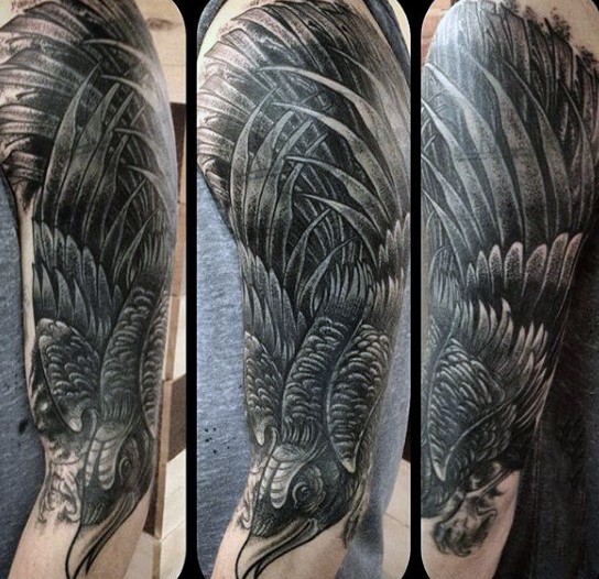 Natural looking black ink fantasy crow tattoo on arm