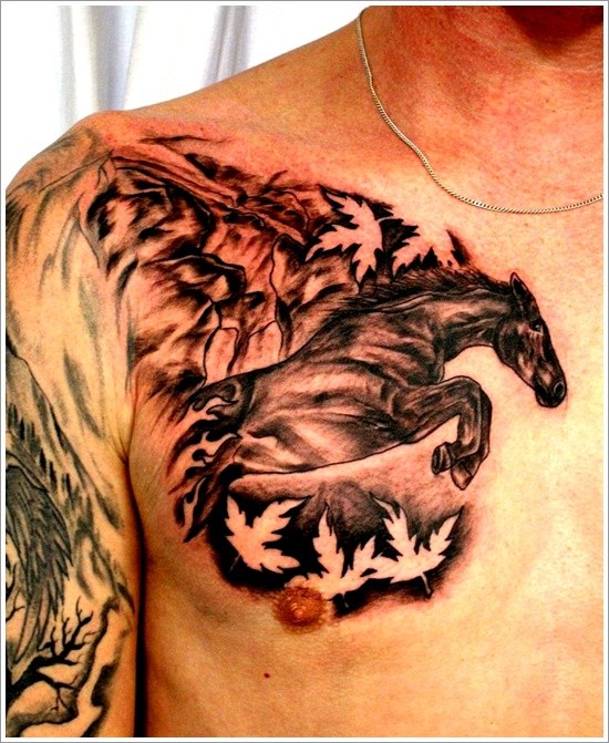 Natural looking black ink running horse tattoo on chest combined with tree leaves