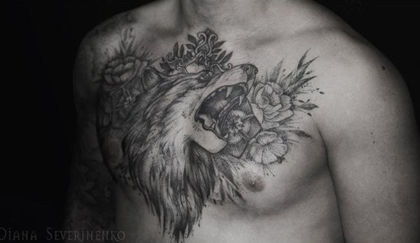 Natural looking black ink wolf tattoo on chest with flowers