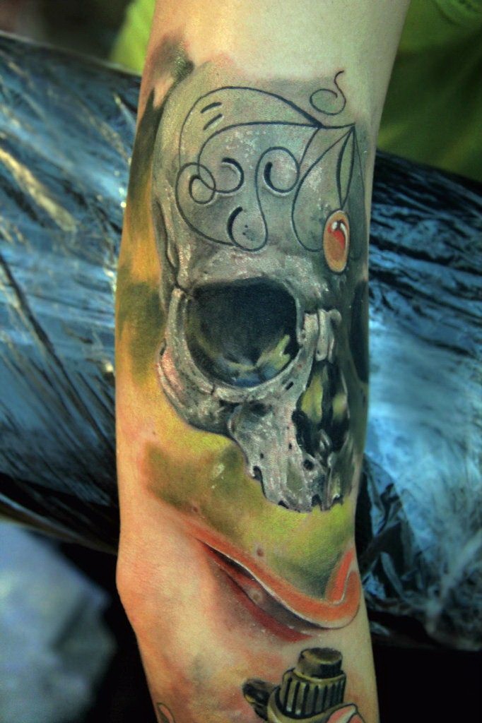 Natural looking colored arm tattoo of human skull with ornaments