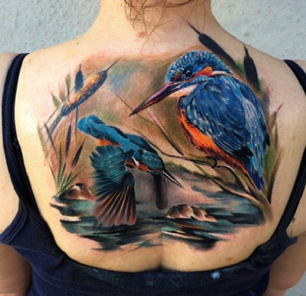 Natural looking colored back tattoo of birds