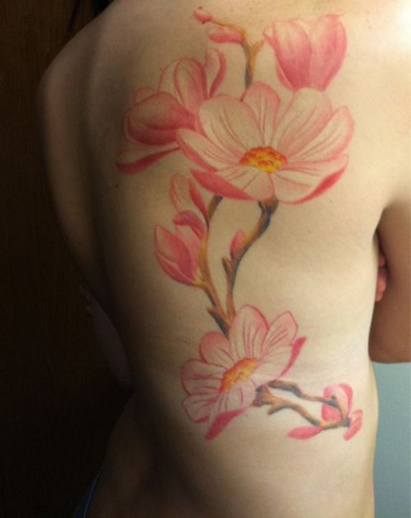 Natural looking colored back tattoo of big cool flowers
