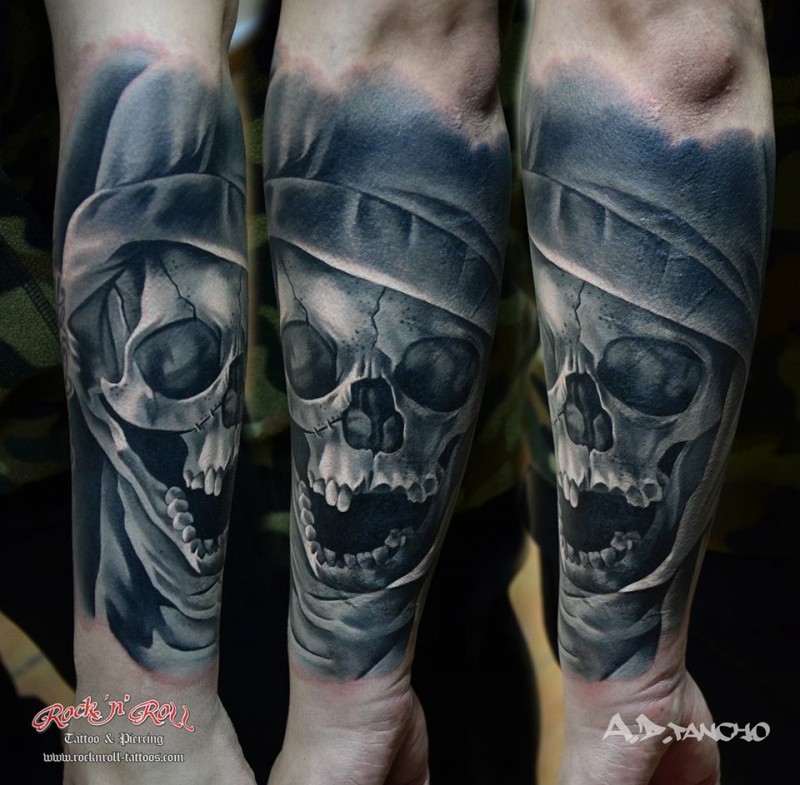 Natural looking colored corrupted ancient human skull tattoo on forearm zone