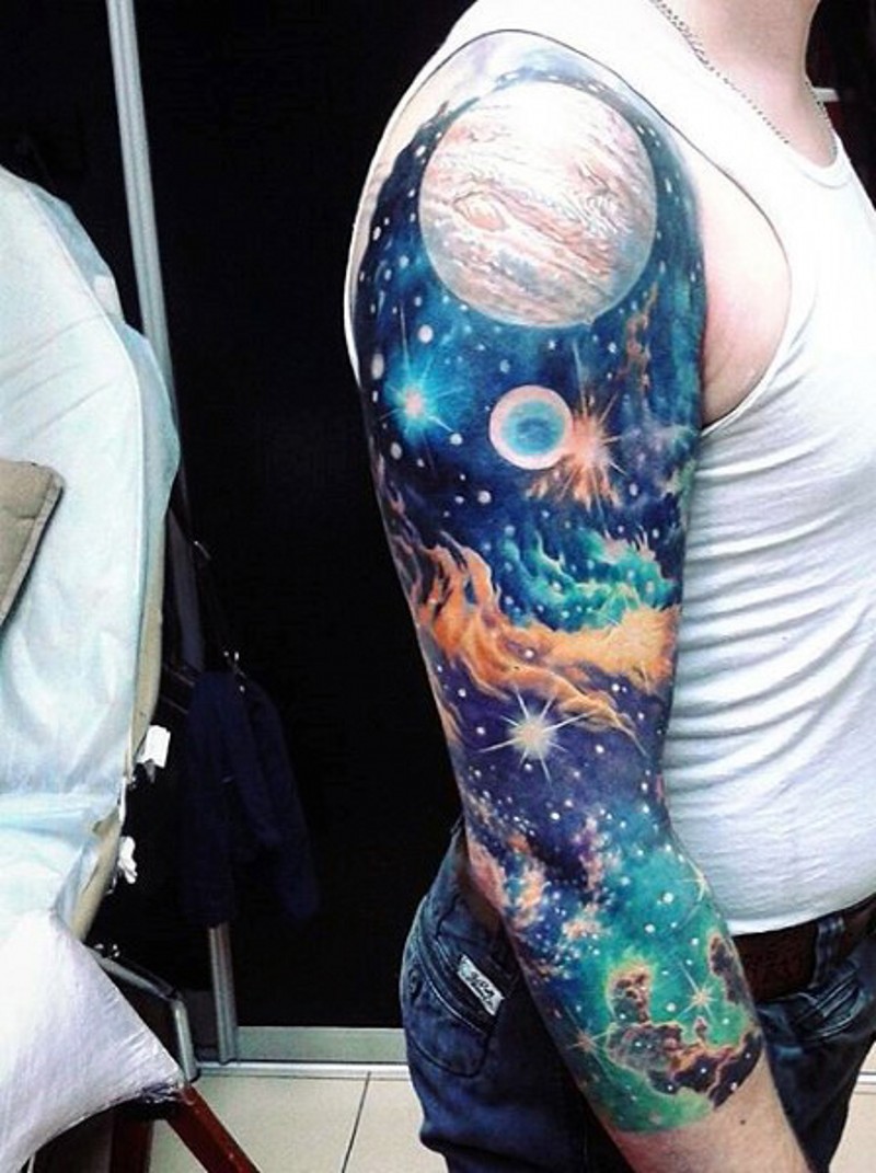 Tatuaje en el brazo,
espacio profundo con planetas y estrellas