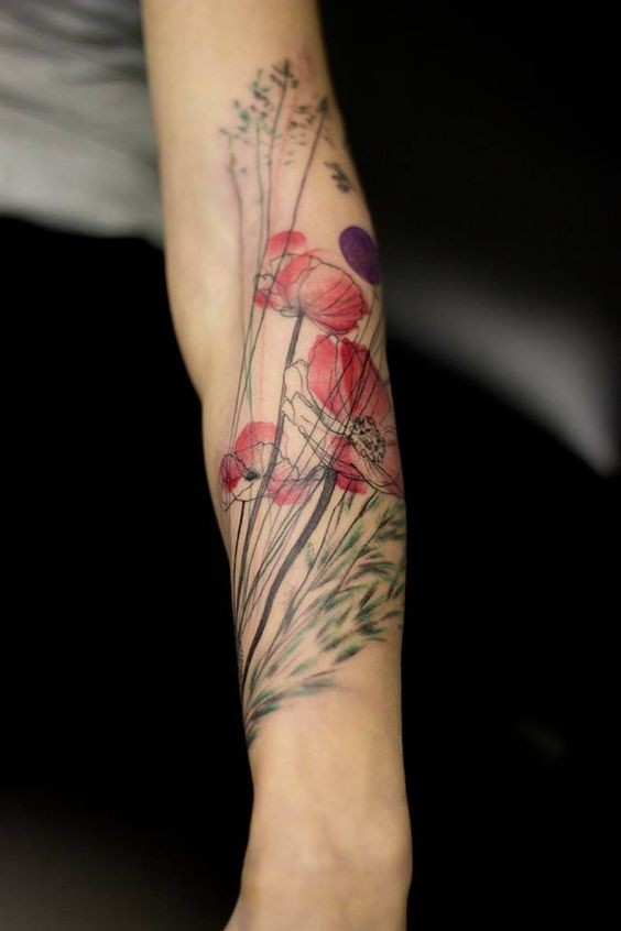 Natural looking colored forearm tattoo of wildflowers