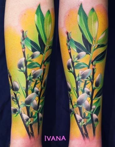 Natural looking colored forearm tattoo of plants