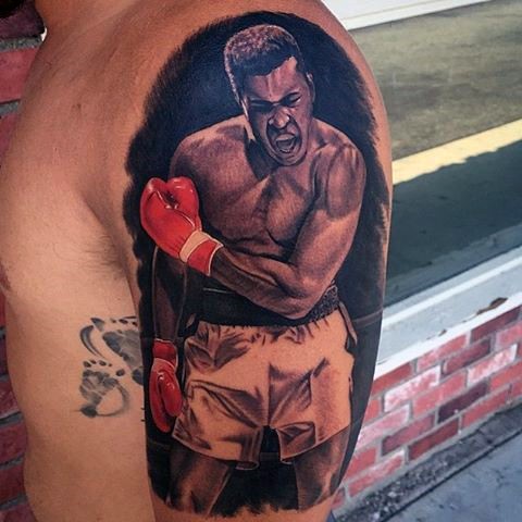 Natural looking colored Muhammad Ali portrait shoulder tattoo