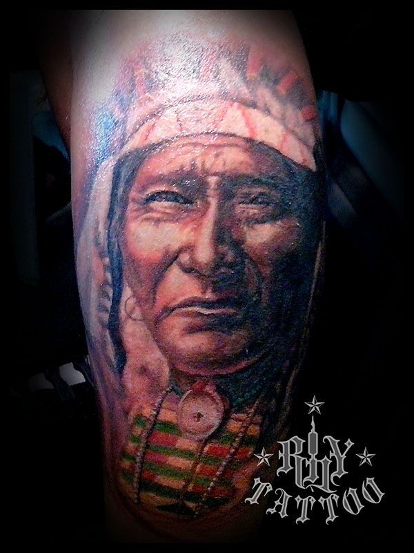 Natural looking colored old Indian portrait tattoo on leg